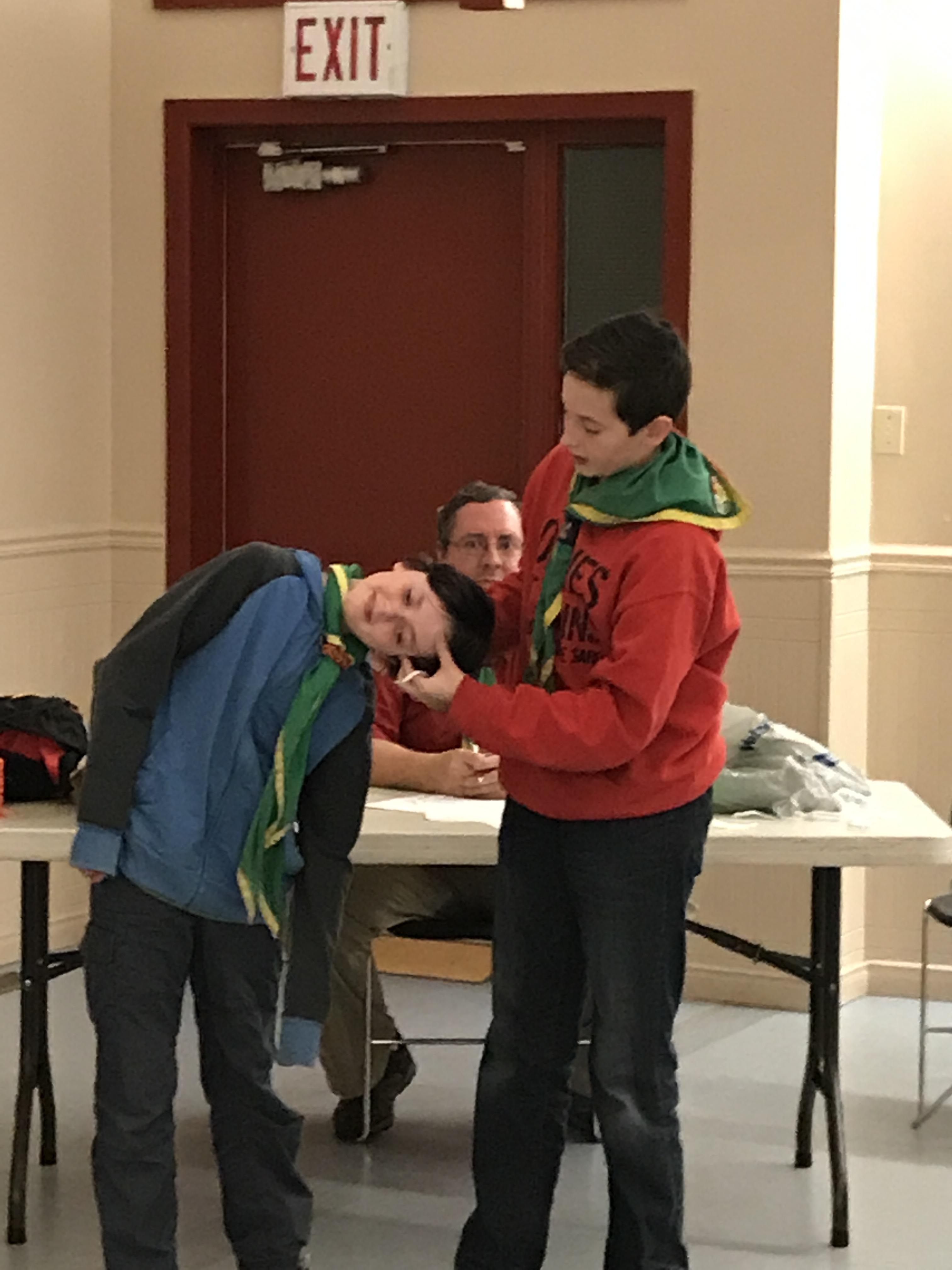 Scouts teaching each other about first aid